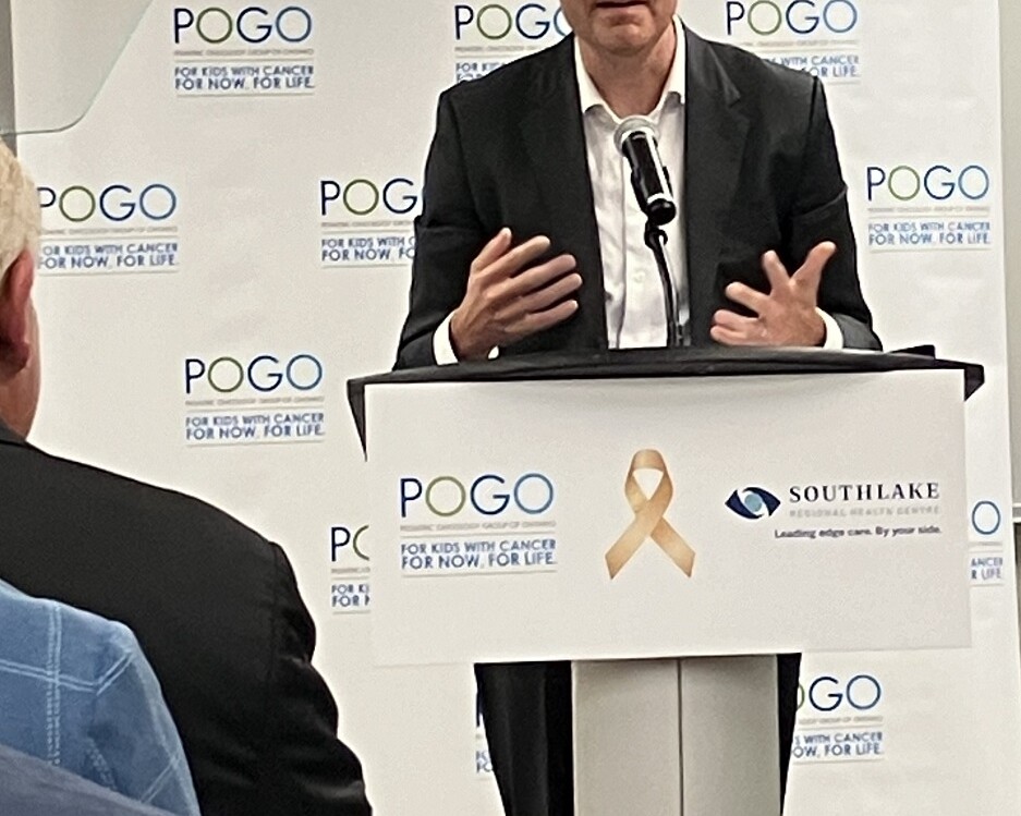 Image of gentleman at a pogo podium talking