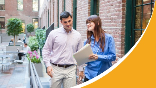 Banner for PRU Trainee Grant Man walking along street with lady reviewing documents